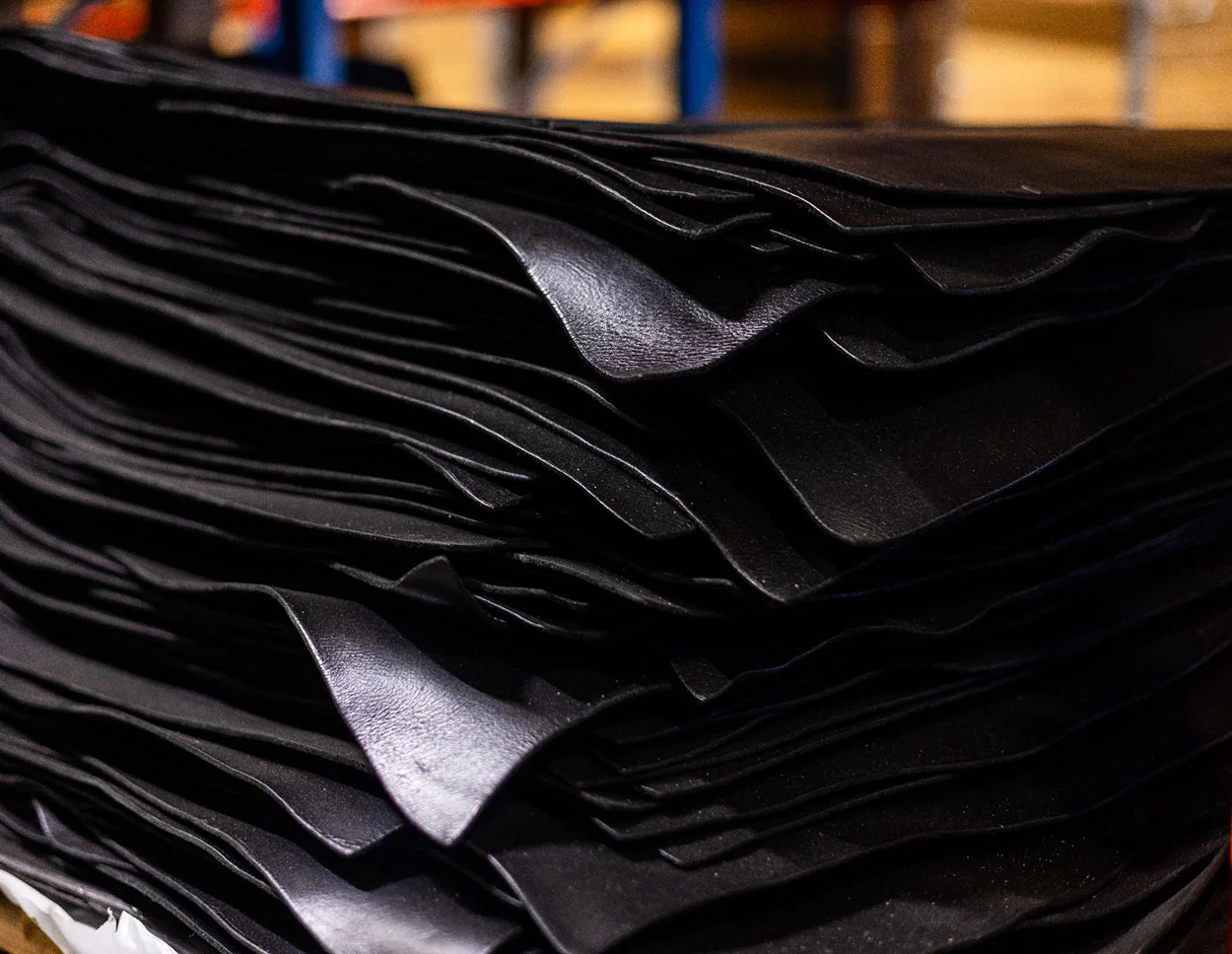 Black leather hide materials stacked in the HongDing factory