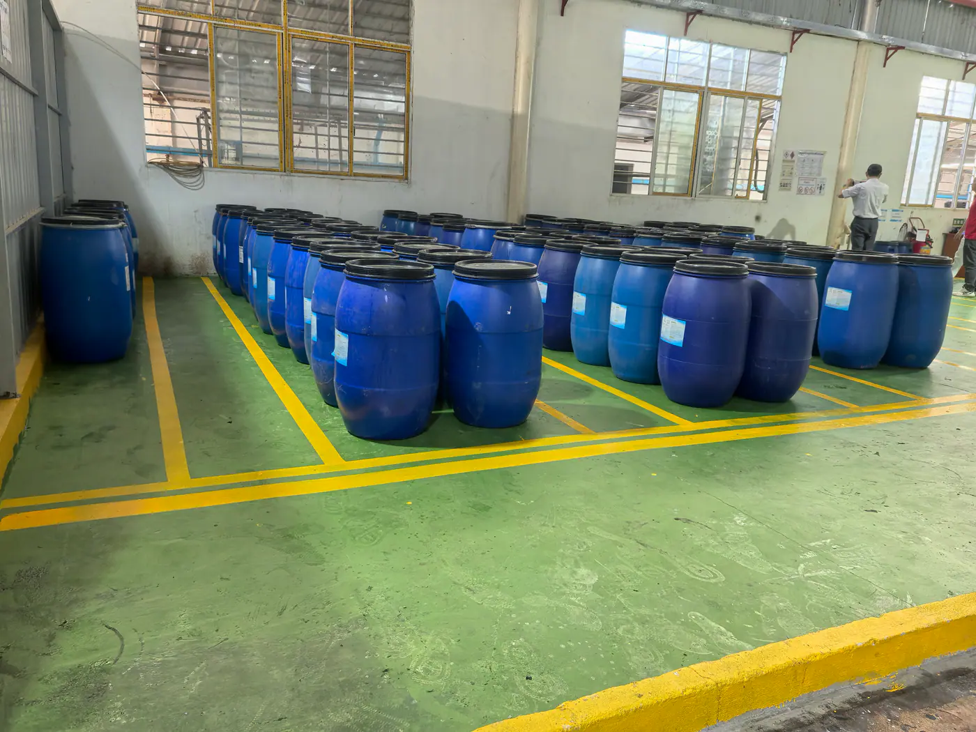 Labelled chemical containers inside a belt production facility
