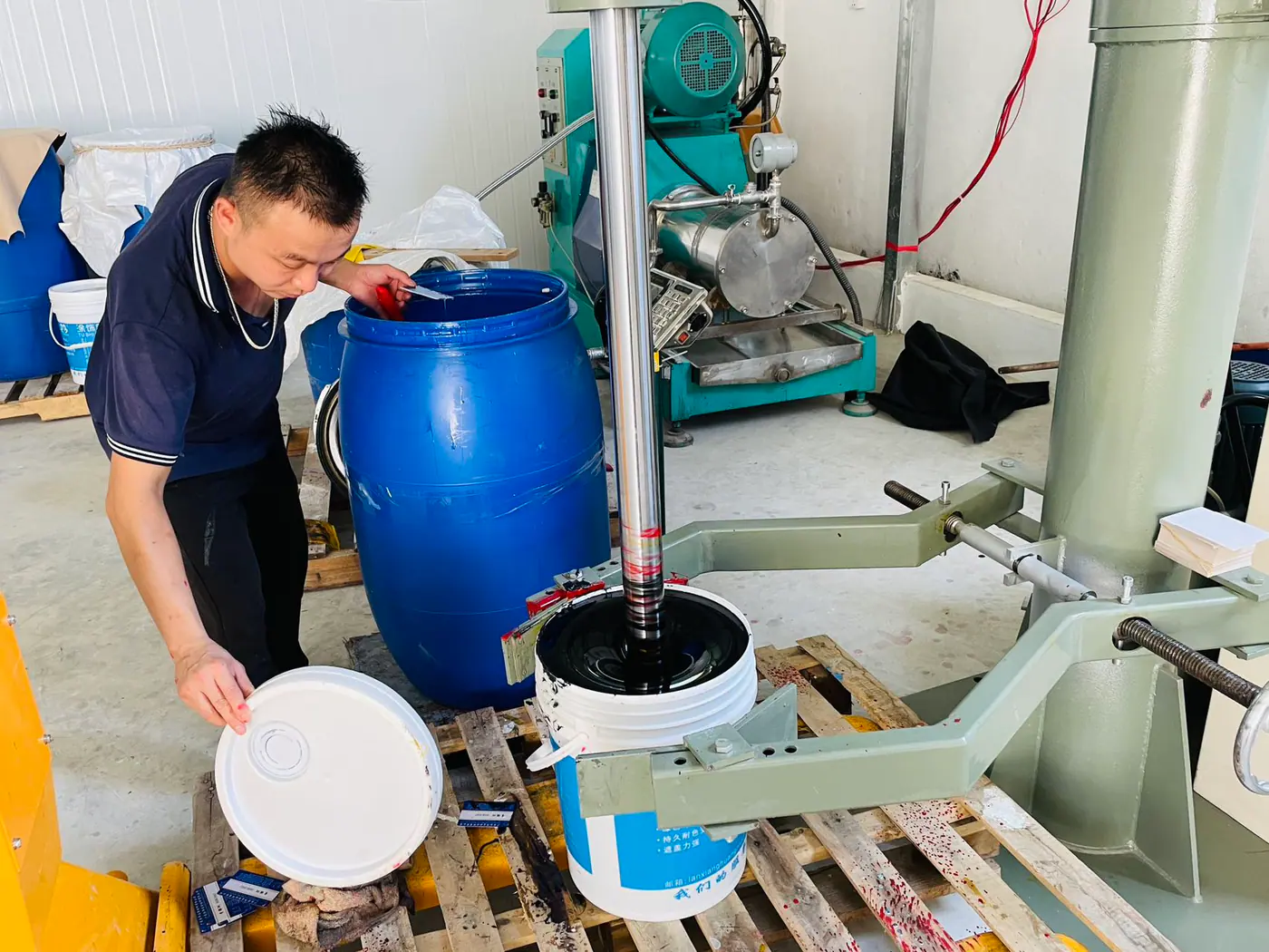 technician mixing leather finishing chemicals and pigments