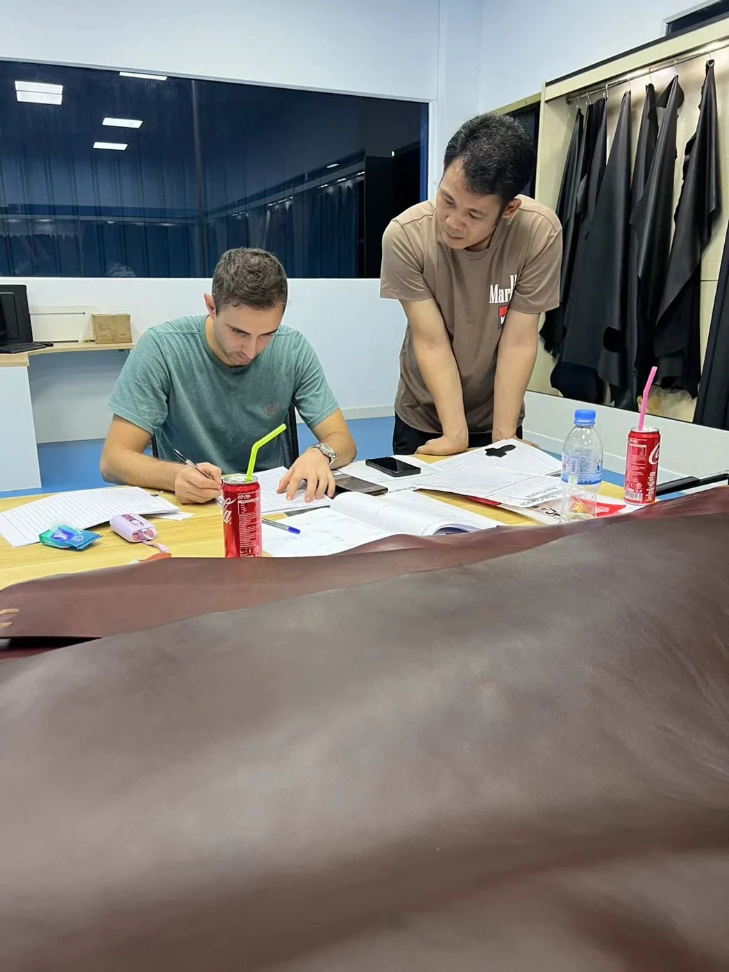 sourcing team reviewing a full leather hide for a belt development program