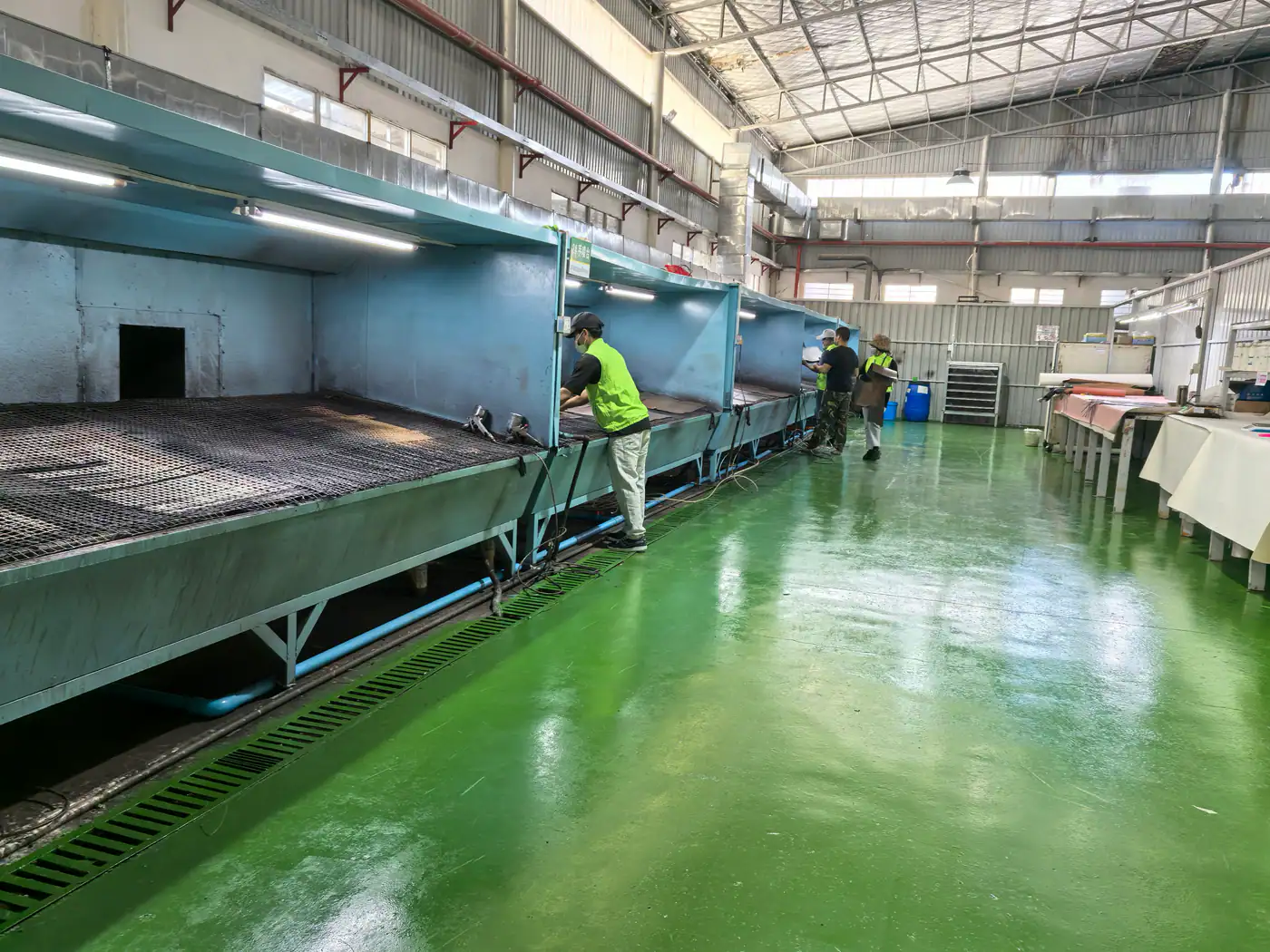 leather spray finishing line with workers monitoring production