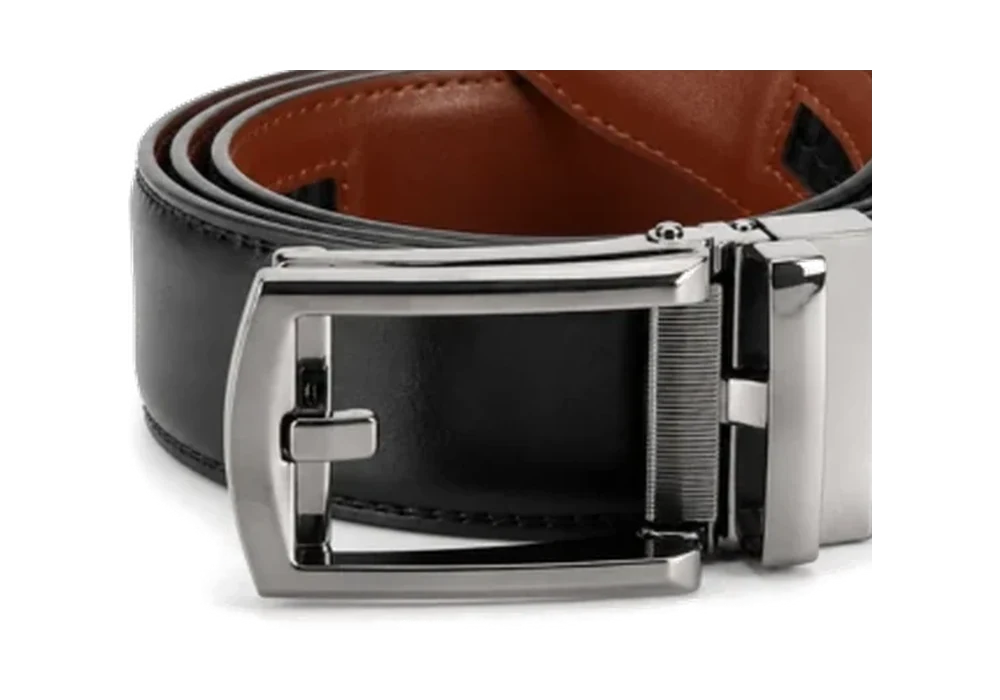 Close view of a polished silver automatic belt buckle attached to a black strap