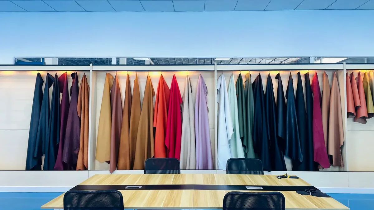 Physical leather color and material samples displayed in a sample room
