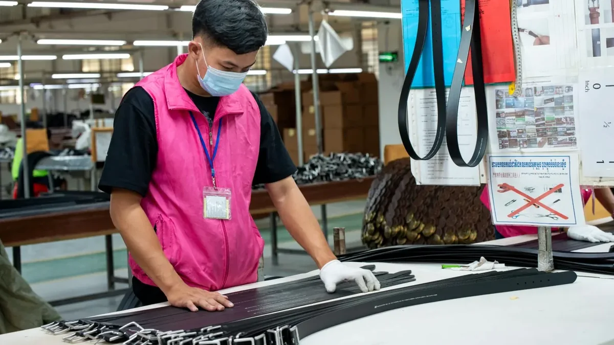 Belt inspector checking finished straps at a worktable