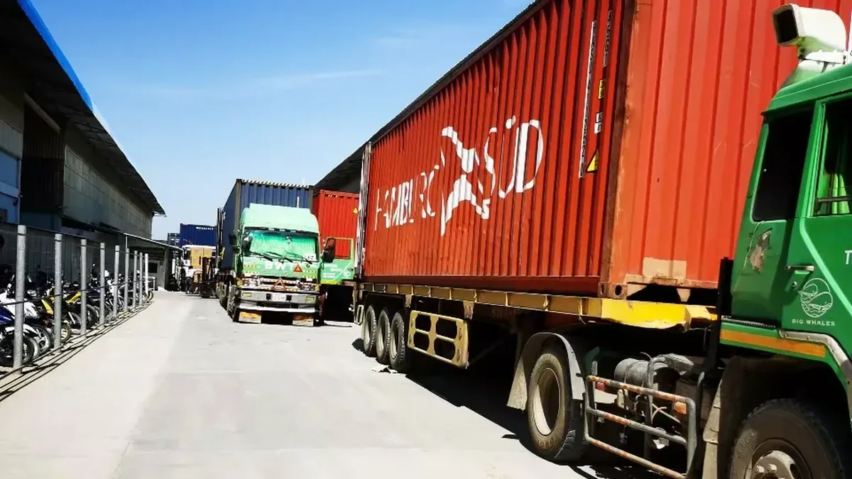 Loaded export trucks at a factory shipping area
