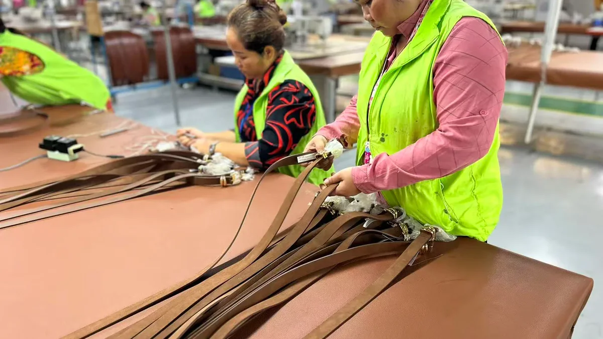 Operators positioning leather panels before cutting