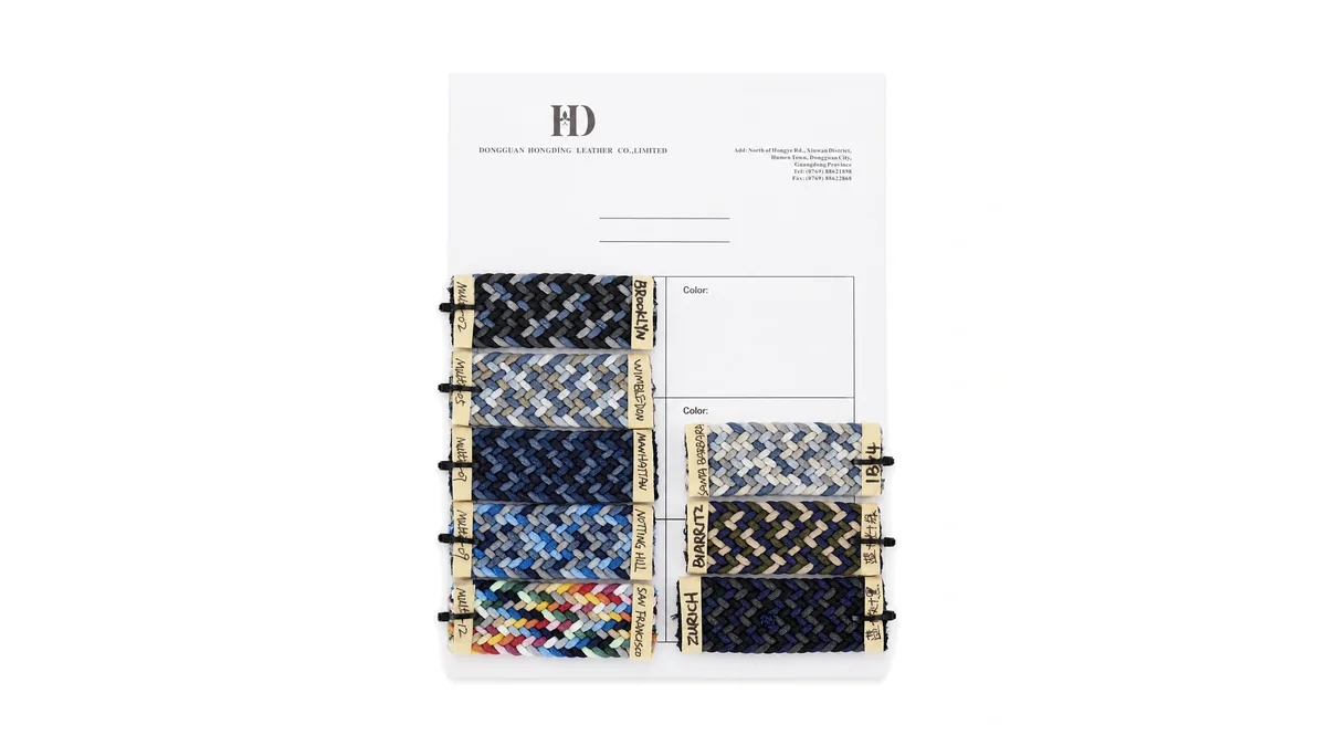 Physical woven webbing sample book with multiple colors and patterns